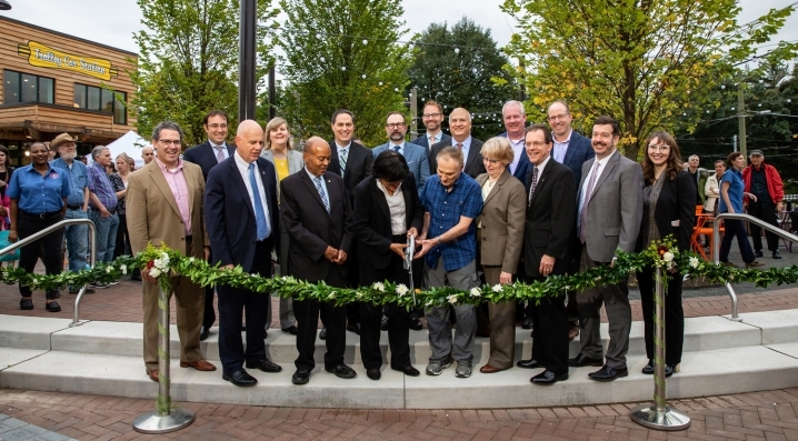 Community leaders join the ribbon cutting for Trolley Portal Gardens 