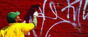 A UCD crewmember removing graffiti 