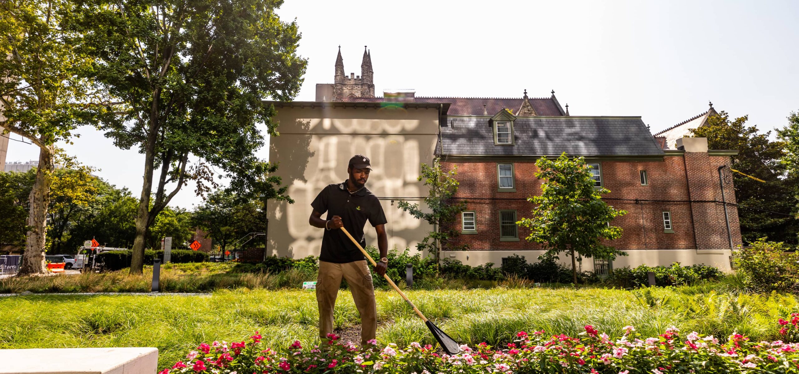 University City District Man Cleaning Yard