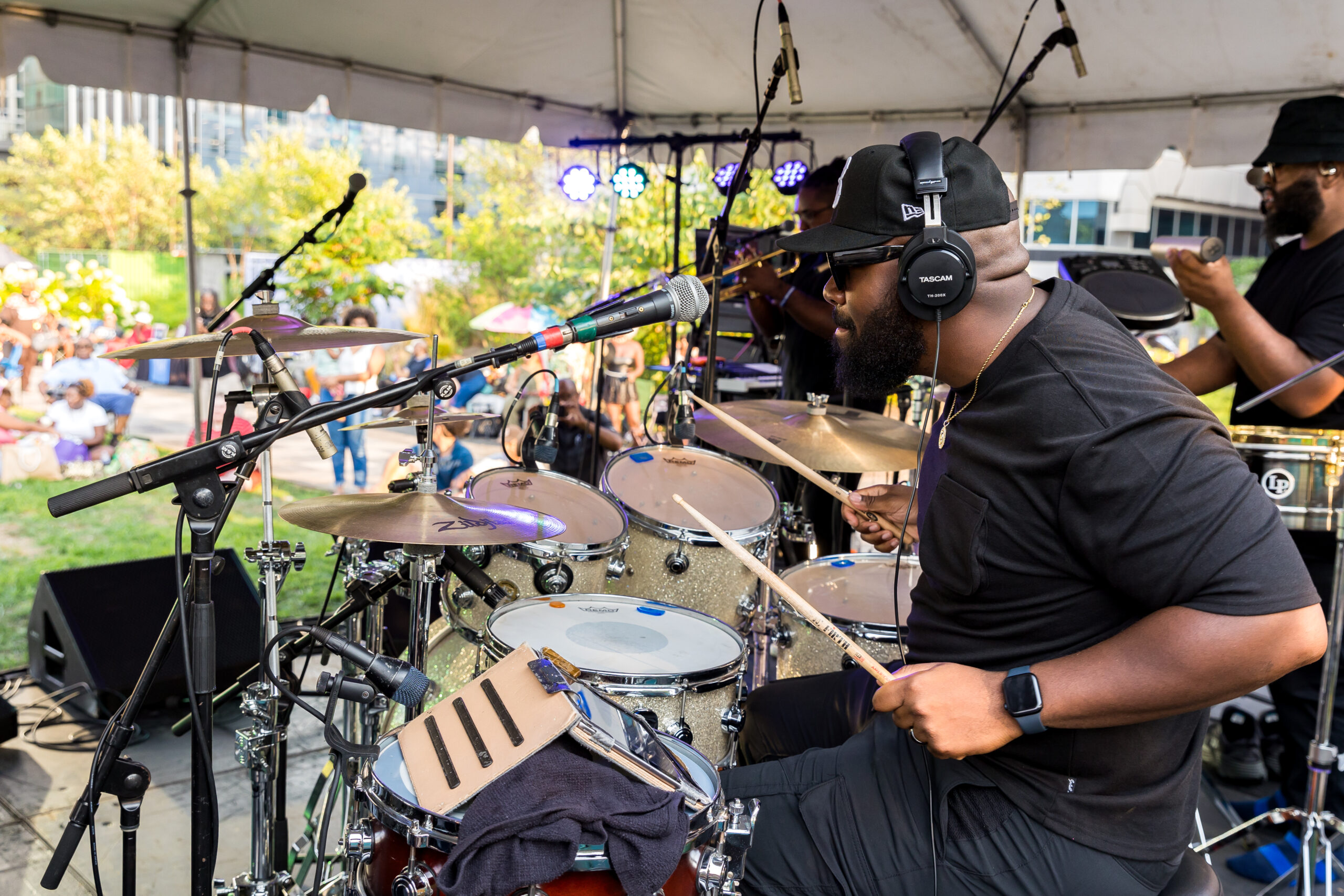 A drummer performs in front of a crowd during the University City Summer Series at the Lawn at uCity Square.