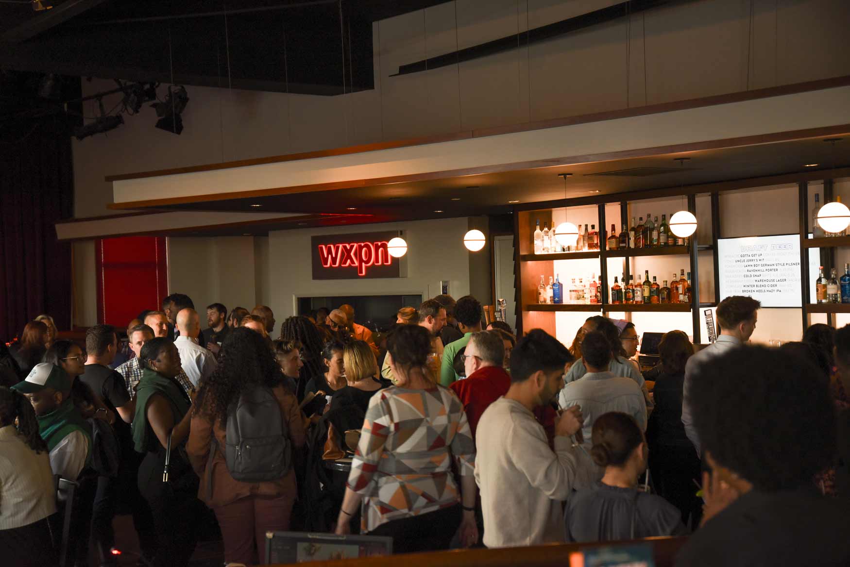 University City Mix Happy Hour crowd socializing at a bar
