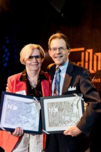 Former UCD board members Maureen Rush and Joe Trainor receiving gifts during the State of University City 2023