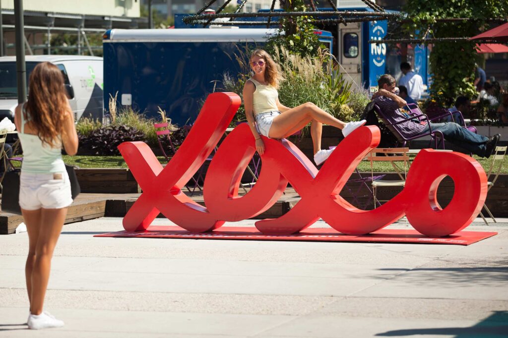 The large red Visit Philly XOXO statue at The Porch at 30th Street Station