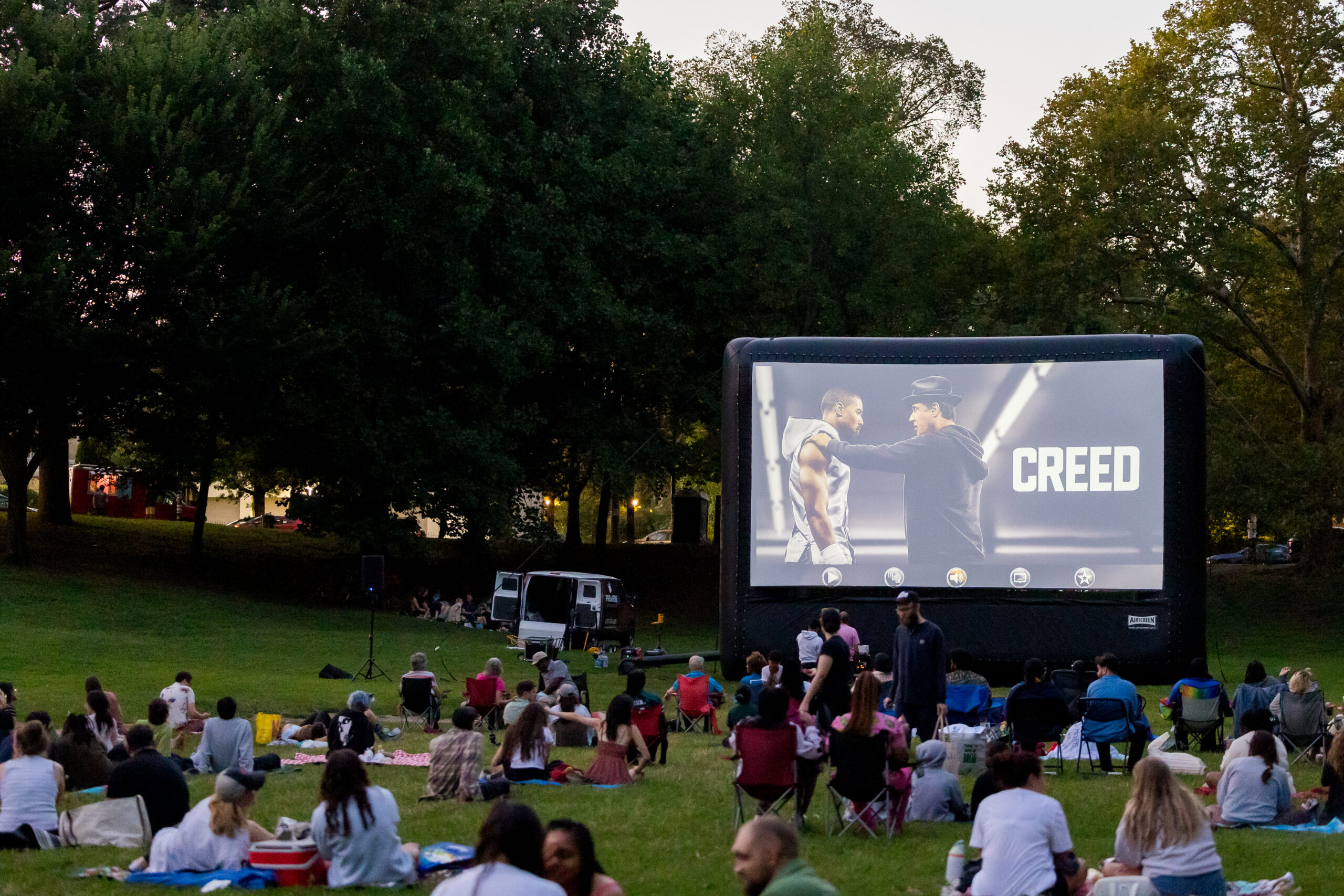A crowd enjoys an outdoor movie at Movies in Clark Park.