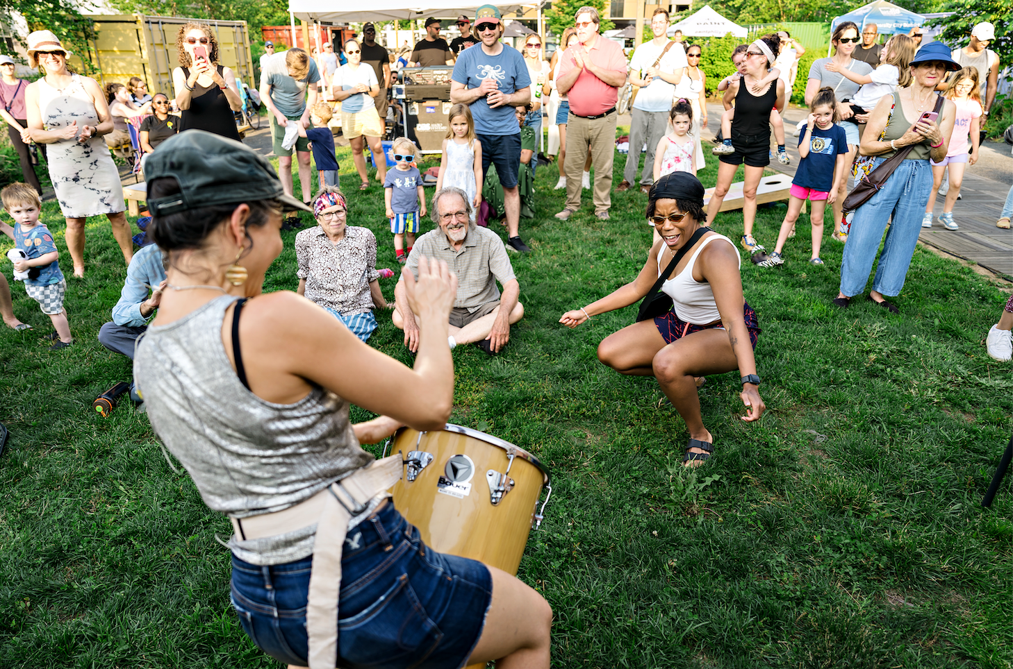 A group of people dancing at an outdoor concert