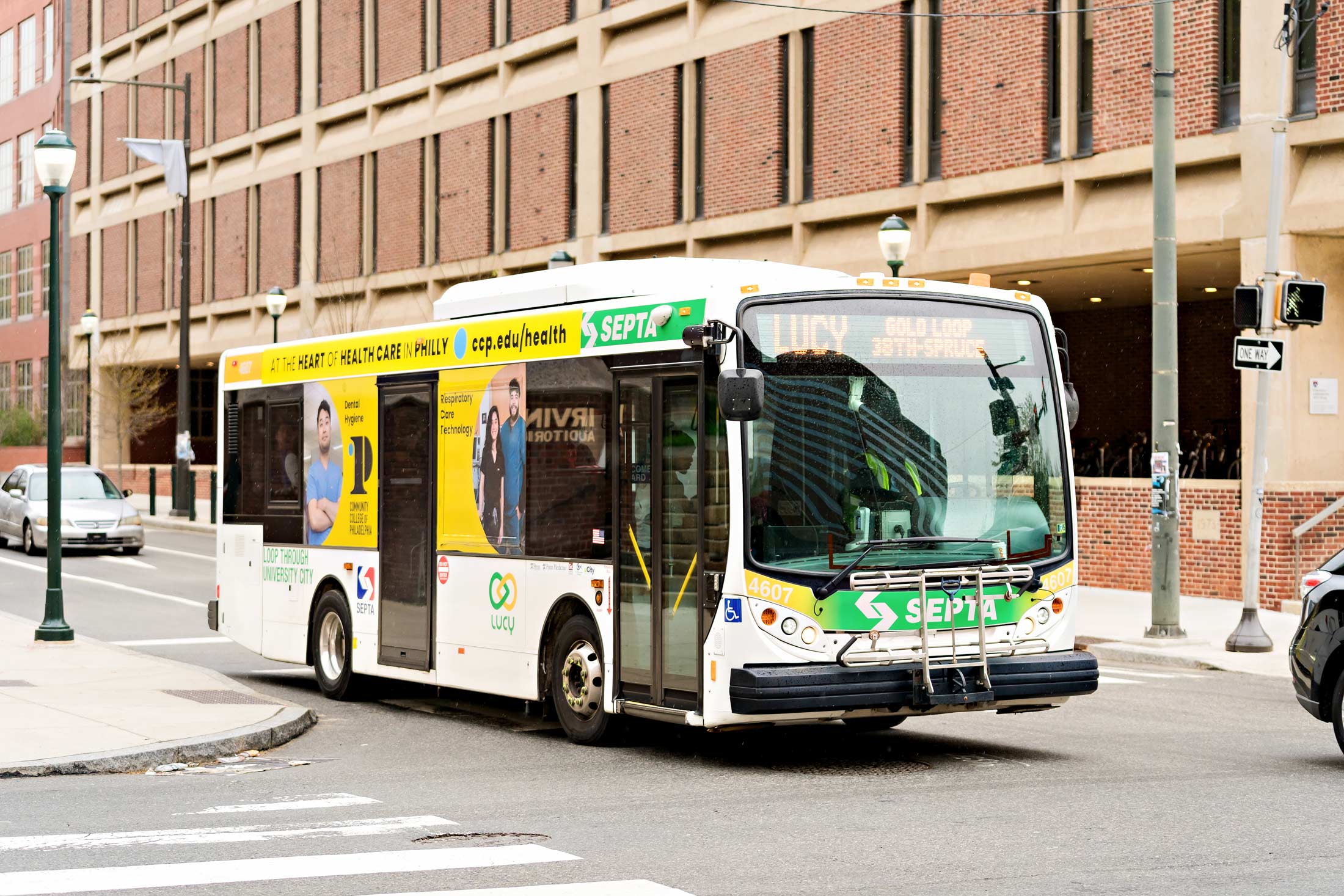 An image of a LUCY bus running through University City