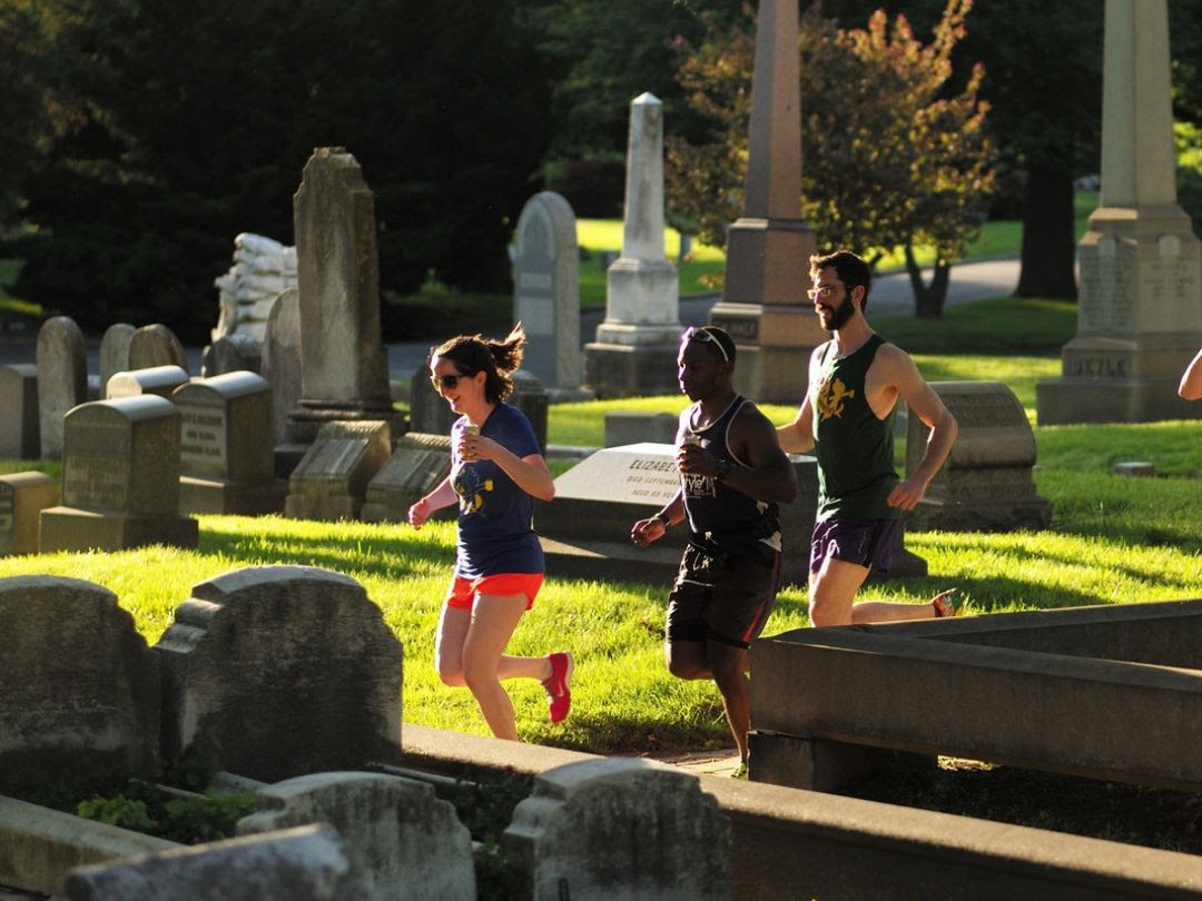 Group of 3 people go for a job through Woodlands Cemetery