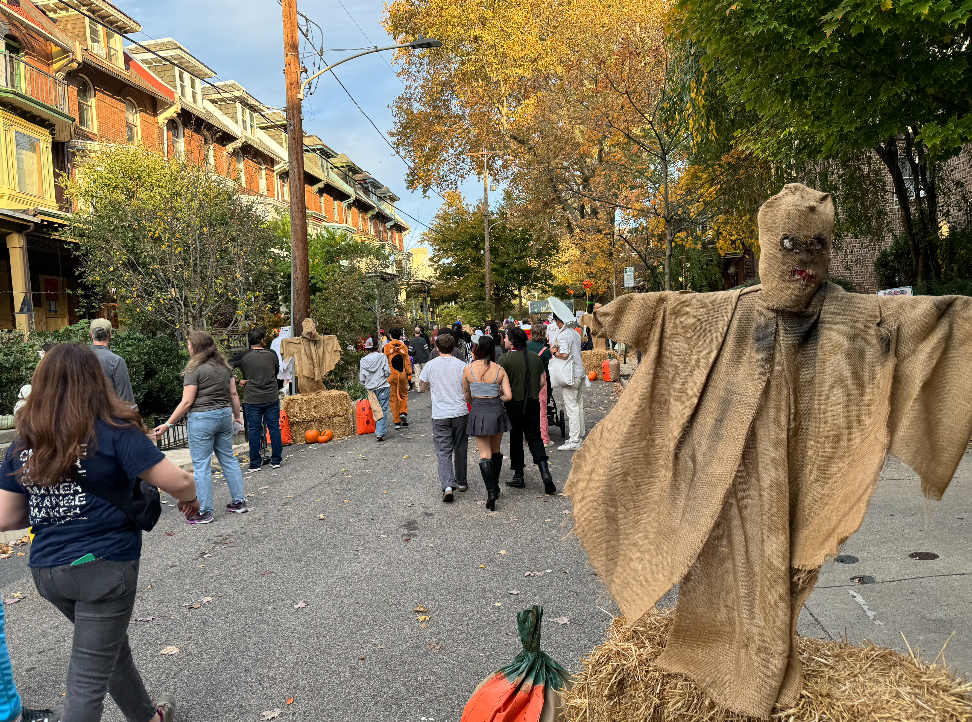 Photo from the West Philadelphia Tot parade, showing a halloween procession through West philadelphia