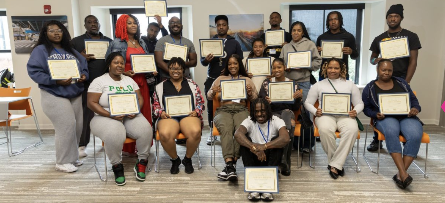 A group of Skills Initiative graduates pose with their certificates.