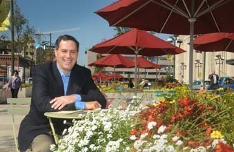 UCD's President Matt Bergheiser sits at a picnic table at The Porch at 30th Street Station