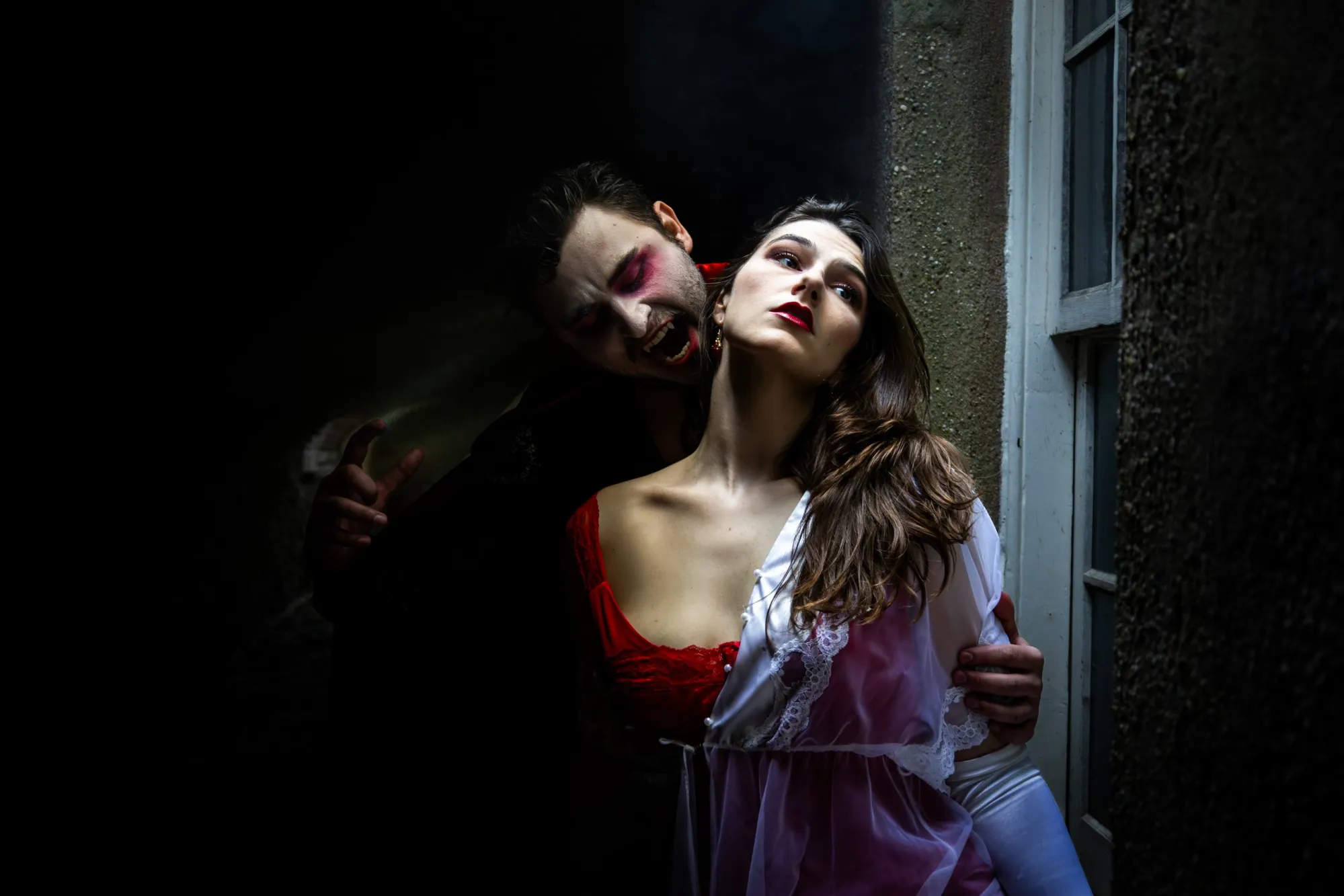 Photo from Curio Theatres Dracula play. Dracula swoops in on a woman.