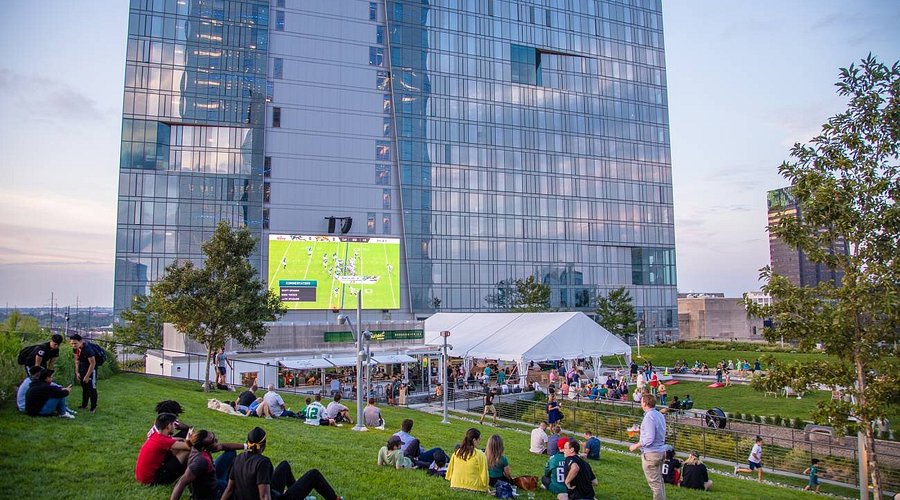 People watching a movie at the Cira Green rooftop lounge