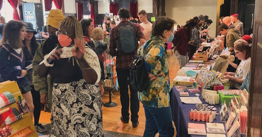 People shop at an indoor market at the Rotunda