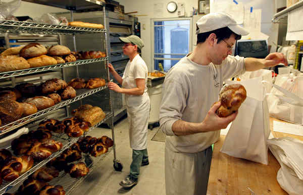 Bakers working behind the counter at Four World Bakery