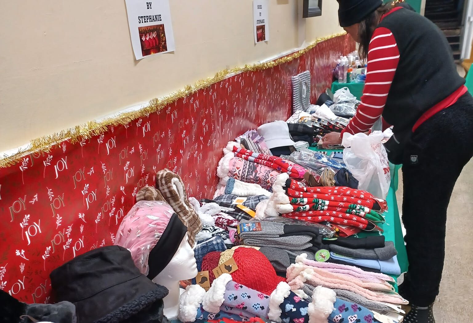 A woman shopping at an indoor holiday marekt