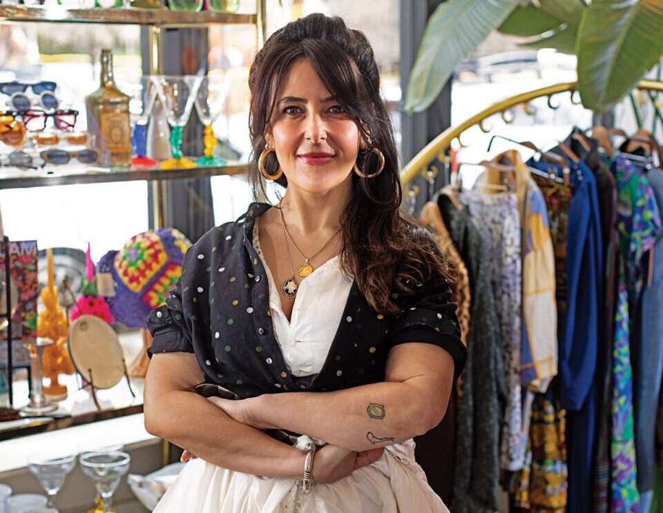 Owner of Manzanitas poses in her shop, smiling.
