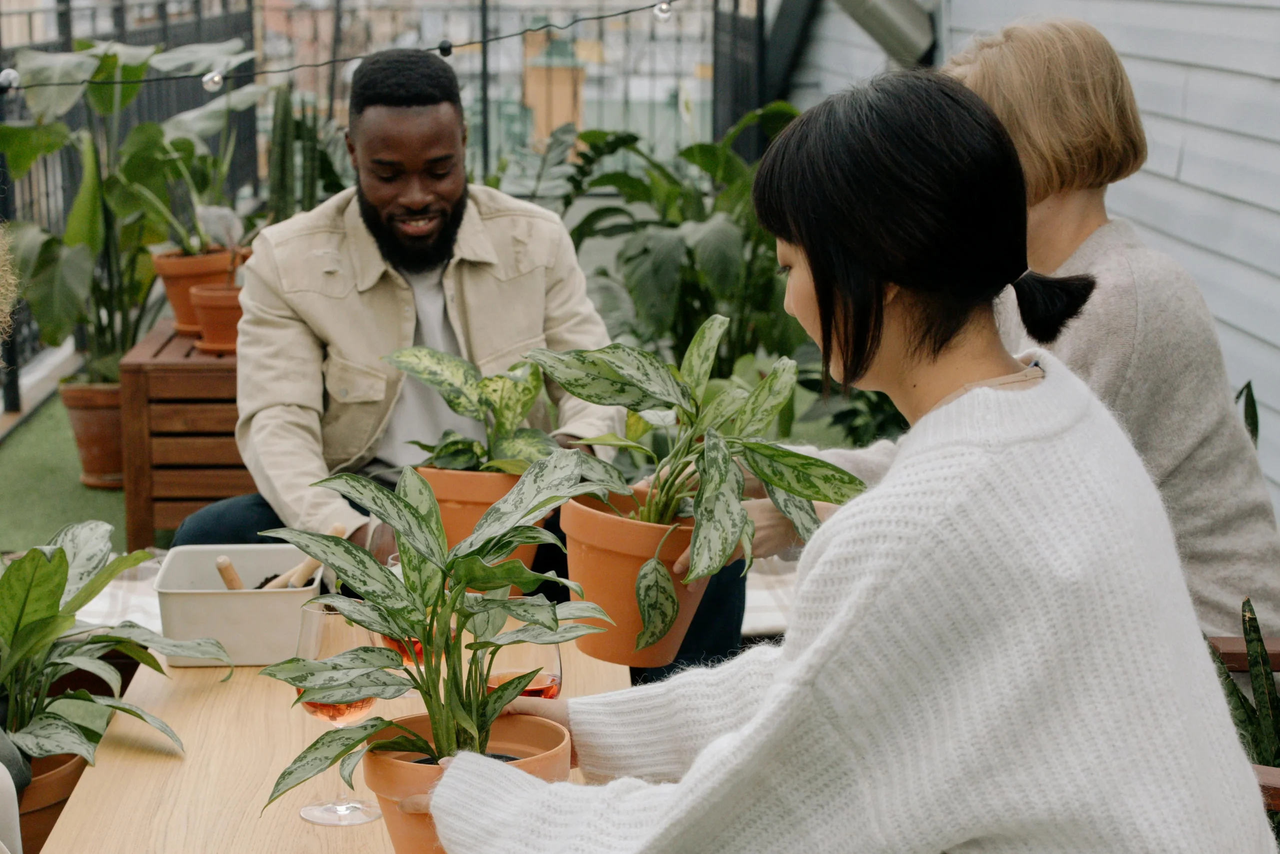 People smiling while participating in a plant workshop