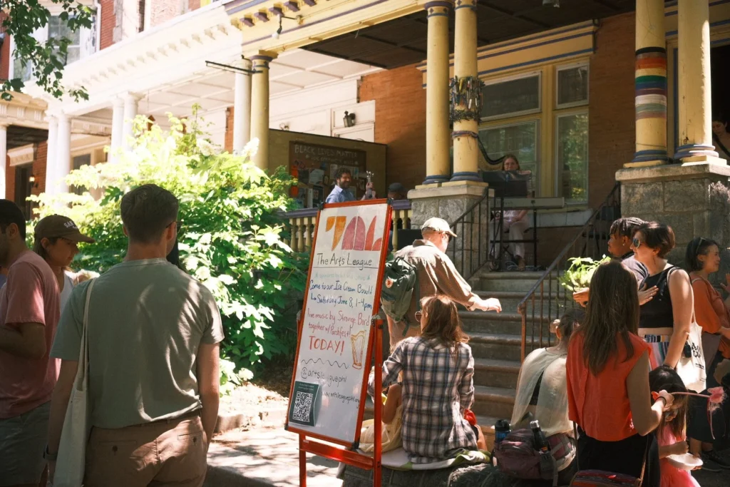 Community members sit outside of The Arts League in West Philadelphia