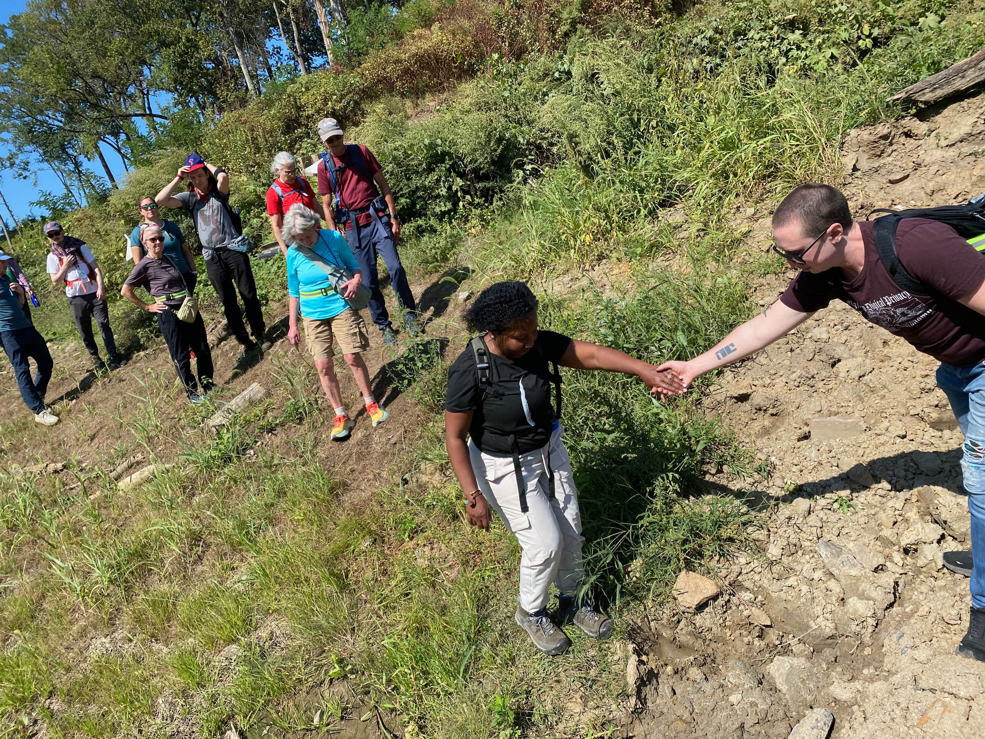 A group hikes through the forest