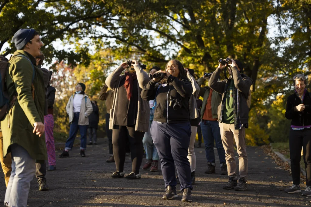 A group of people at Woodlands Cemetery participating in a group bird watch.