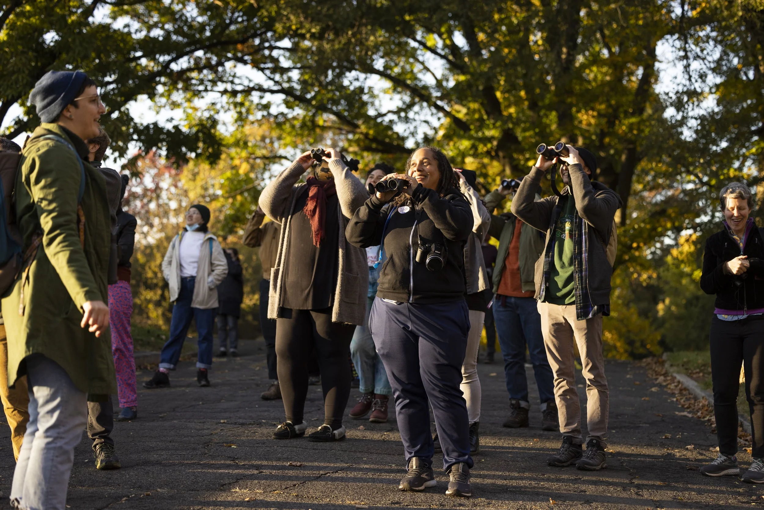 A group of people at Woodlands Cemetery participating in a group bird watch.