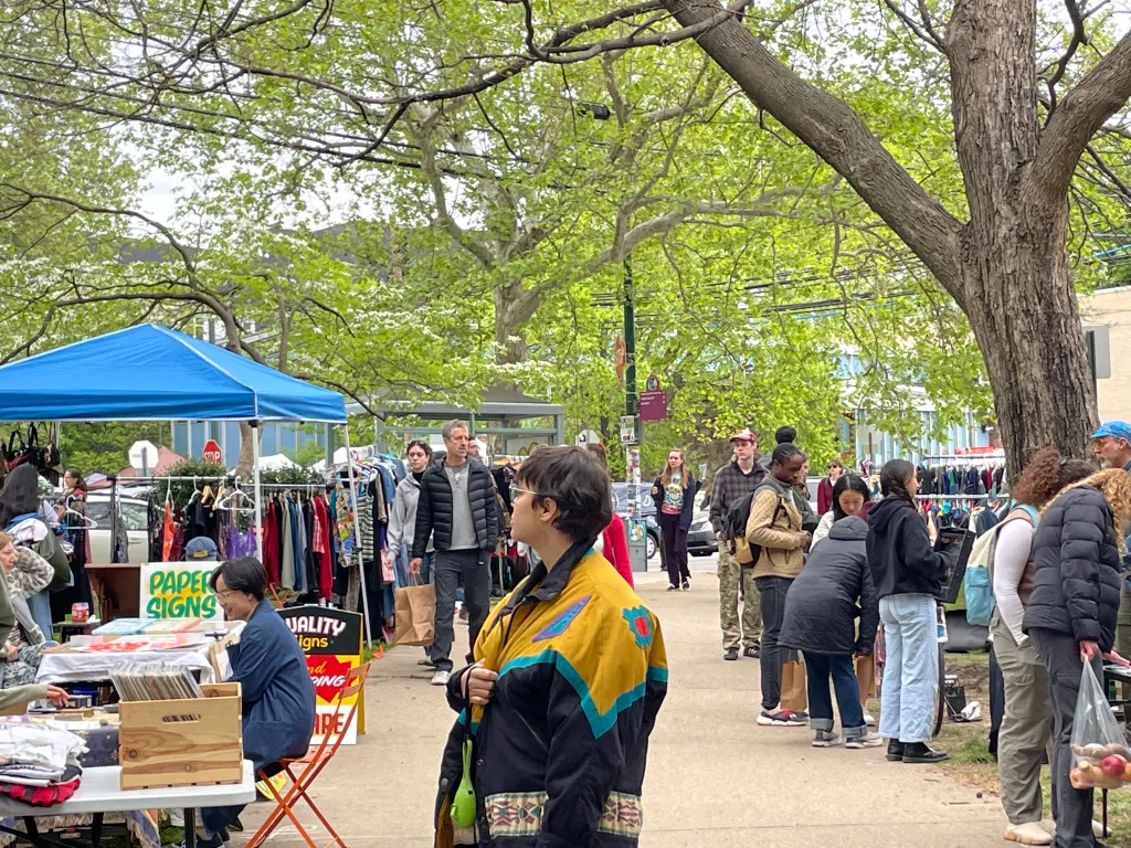 A group of shoppers explore the West Philla Biazarre outdoor market in West Philly