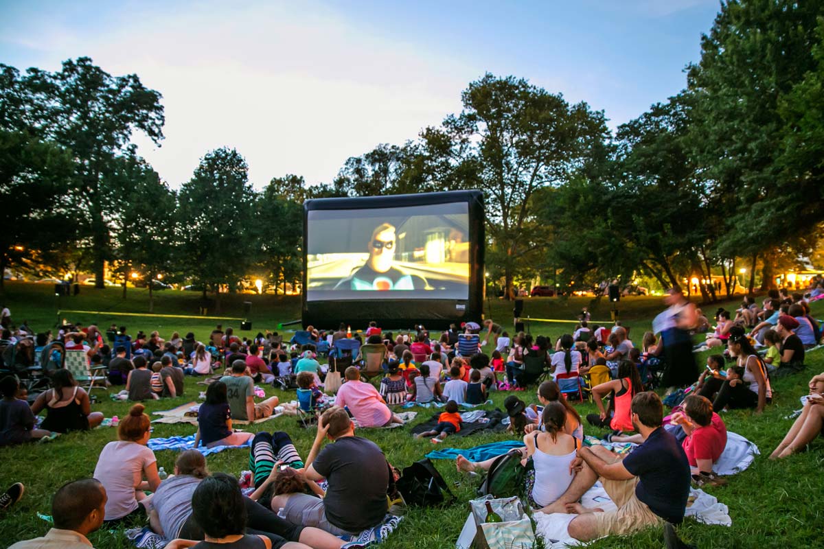 A crowd enjoys an outdoor movie at Movies in Clark Park.